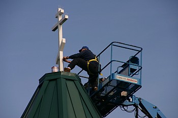 Church building completed with the installation of the cross